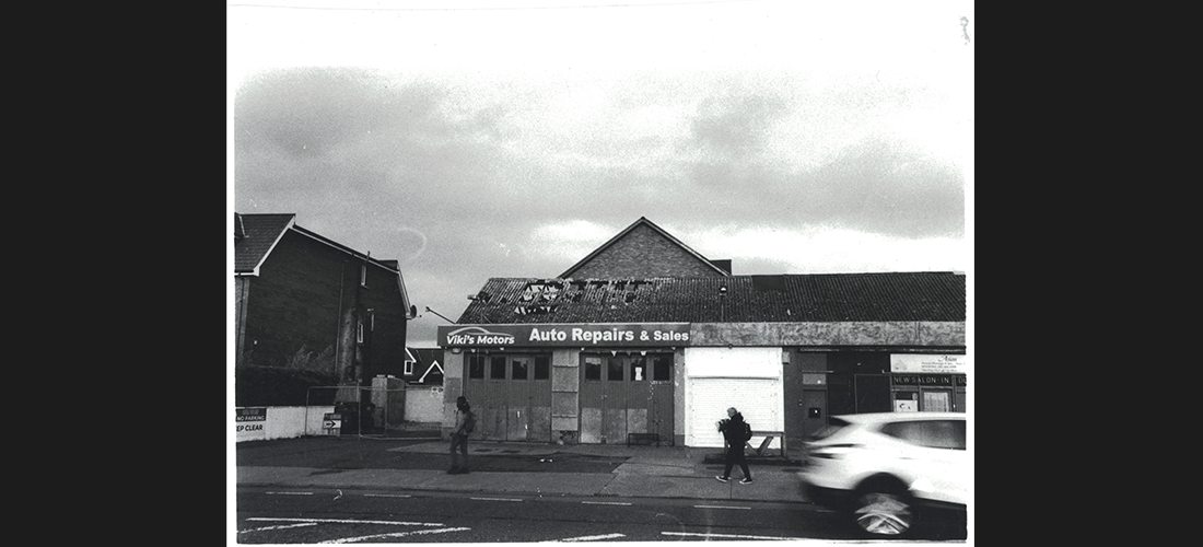 A black and white photograph of a run down shop